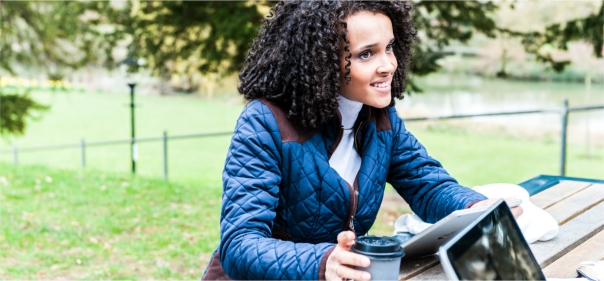 Arden University student studying outside on picnic bench